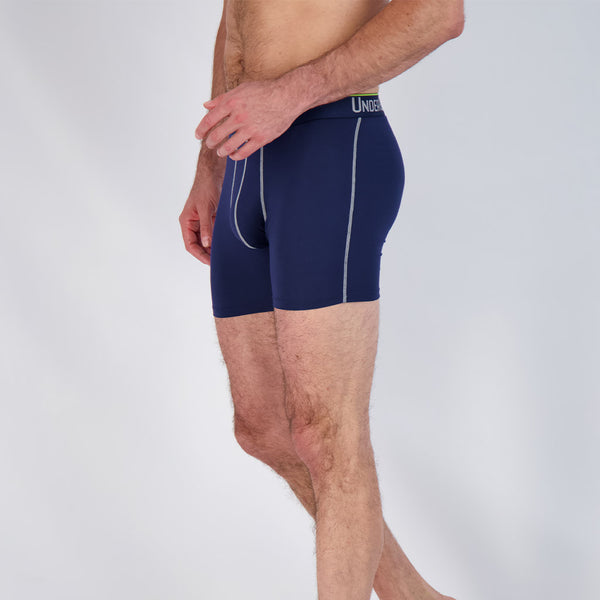 navy boxer brief by undergents side view facing right on slim model. 3 pairs in this package.