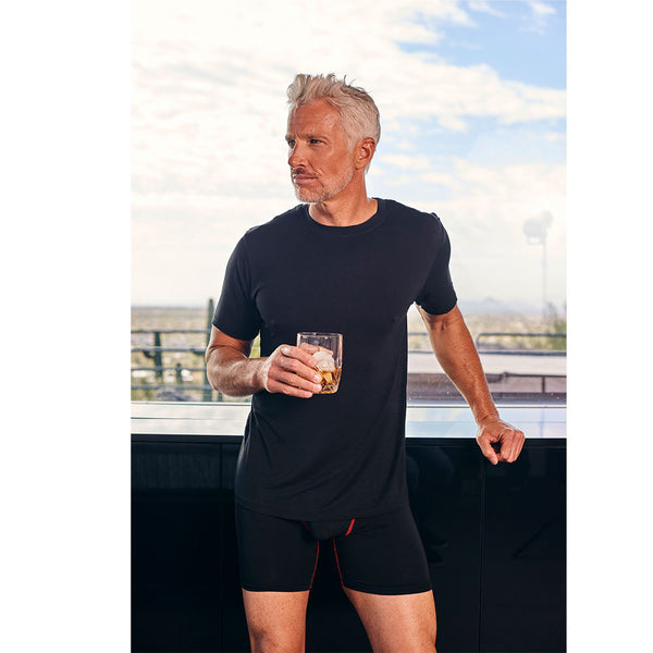The silver fox model wearing the 6 inch boxer brief by UnderGents and a swagger lounge wear shirt