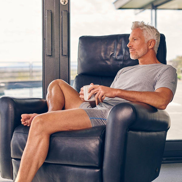 swagger lounge shirt by undergents in heather grey. model contemplating the joy and comfort with coffee